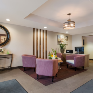Best Western Colonel Butlers Lobby with 4 mauve coloured chair positioned around a round table with a bouquet of flowers.