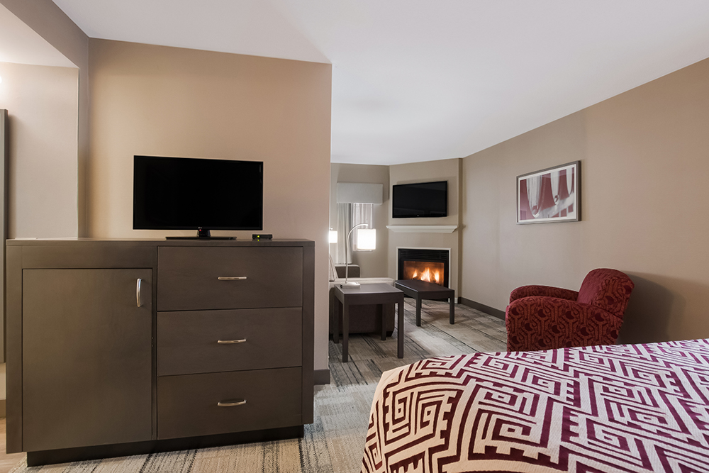 Best Western King suite with seating area and a fireplace.