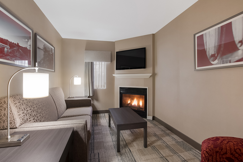 Best Western King suite with sofa and a fireplace.